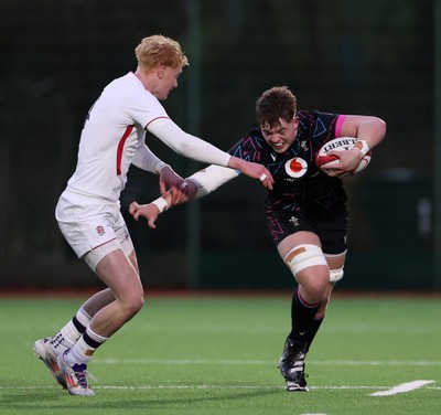 191225 - Wales U19s v England U19s - International Friendly - Cerrig Smith of Wales is tackled by Krystof Wood of England 