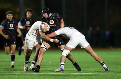 191225 - Wales U19s v England U19s - International Friendly - Gabe Williams of Wales is tackled by Victor Worsnip of England 
