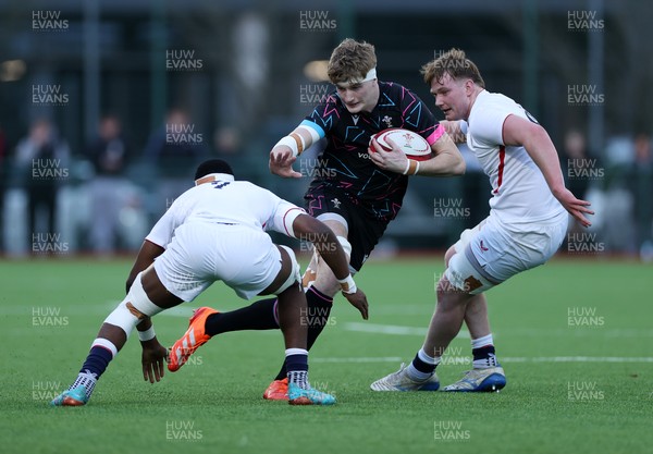 191225 - Wales U19s v England U19s - International Friendly - Osian Williams of Wales is tackled by Tate Williams of England 