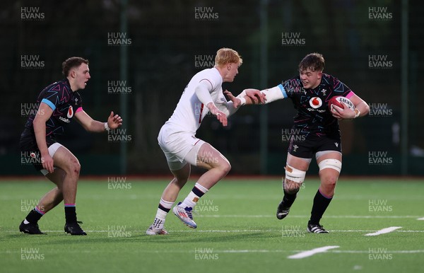 191225 - Wales U19s v England U19s - International Friendly - Cerrig Smith of Wales is tackled by Krystof Wood of England 