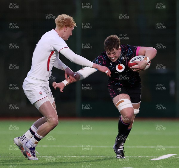 191225 - Wales U19s v England U19s - International Friendly - Cerrig Smith of Wales is tackled by Krystof Wood of England 