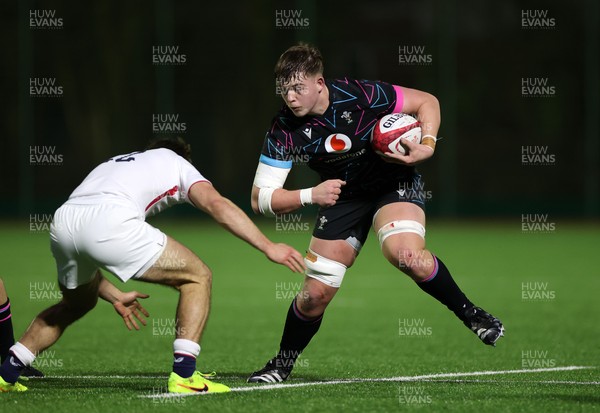 191225 - Wales U19s v England U19s - International Friendly - Cerrig Smith of Wales is tackled by Ollie Batson of England 