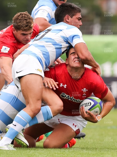 120618 -  Wales U20 v Argentina U20, World Rugby U20 Championship, 5th Place Semi Final - Tiann Thomas-Wheeler of Wales is tackled by Leonel Oviedo of Argentina and Joaquin De La Vega Mendia of Argentina