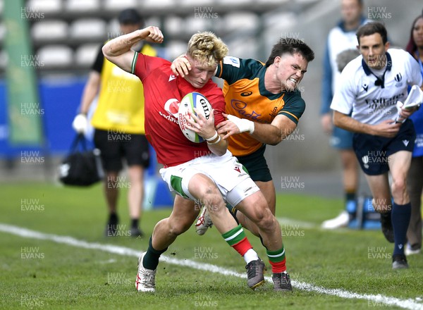 140723 - Wales U20 v Australia U20 - World Rugby Under 20 Championship 2023, 5th place play-off - Harri Houston of Wales tackled by Henry O'donnell of Australia