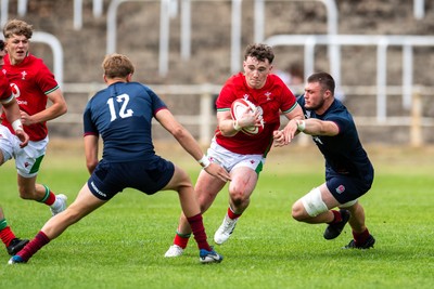 060625 - Wales U20 v England U20 - U20 World Championship Warm Up - Caio James of Wales is tackled by George Timmins of England