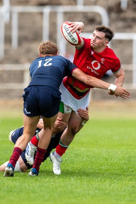 060625 - Wales U20 v England U20 - U20 World Championship Warm Up - Caio James of Wales is tackled by Will Knight of England