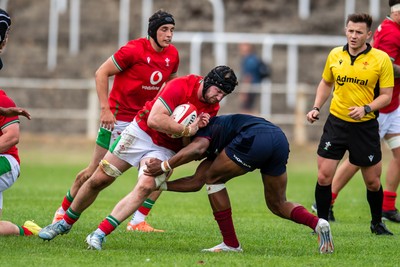 060625 - Wales U20 v England U20 - U20 World Championship Warm Up - Evan Minto of Wales is tackled by Noah Caluori of England