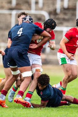 060625 - Wales U20 v England U20 - U20 World Championship Warm Up - Evan Minto of Wales is tackled by Noah Caluori of England and Aiden Ainsworth-Cave of England