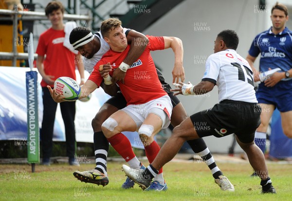 120619 - Wales U20 v Fiji U20 - World Rugby Under 20 Championship -  Tomi Lewis of Wales gets his pass away despite a heavy Fiji tackle