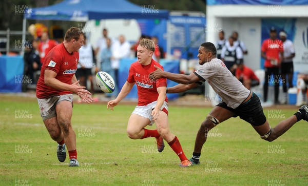 120619 - Wales U20 v Fiji U20 - World Rugby Under 20 Championship -  Sam Costelow of Wales passes to Dewi Lake