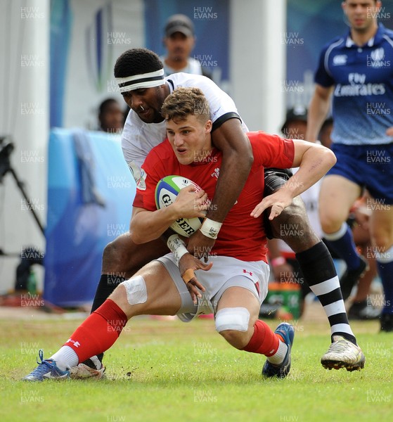 120619 - Wales U20 v Fiji U20 - World Rugby Under 20 Championship -  Tomi Lewis of Wales is wrapped up in a heavy Fiji tackle 
