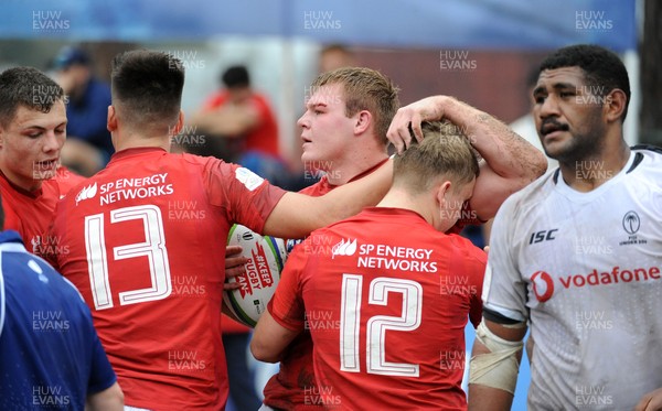 120619 - Wales U20 v Fiji U20 - World Rugby Under 20 Championship -  Dewi Lake of Wales is congratulated by his team mates after driving over the Fiji line for a second half try