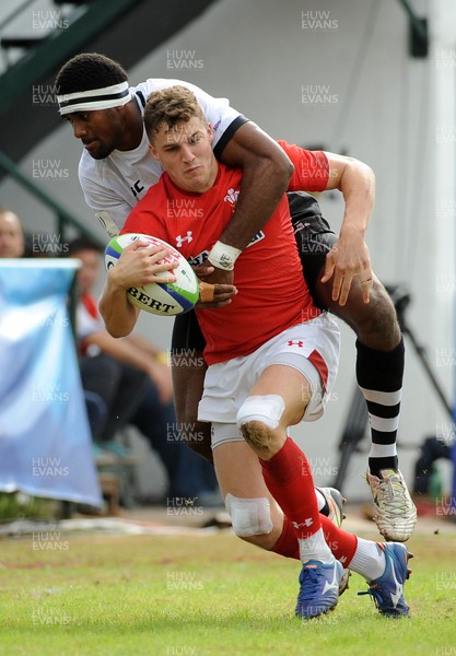 120619 - Wales U20 v Fiji U20 - World Rugby Under 20 Championship -  Tomi Lewis of Wales is wrapped up in a heavy Fiji tackle 