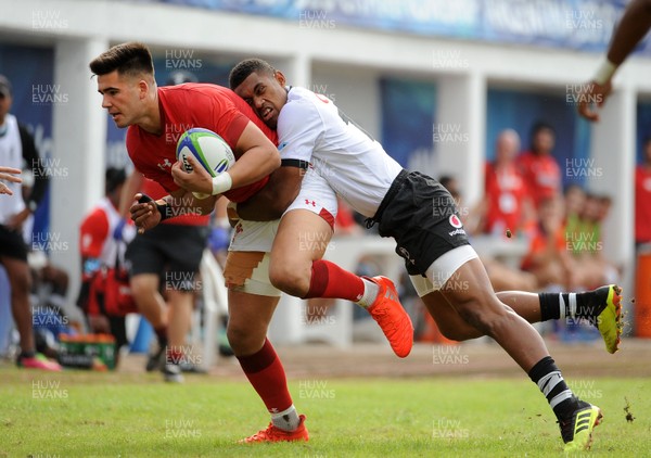120619 - Wales U20 v Fiji U20 - World Rugby Under 20 Championship -  Tiaan Thomas-Wheeler of Wales is tackled by iiaisa Rasaku