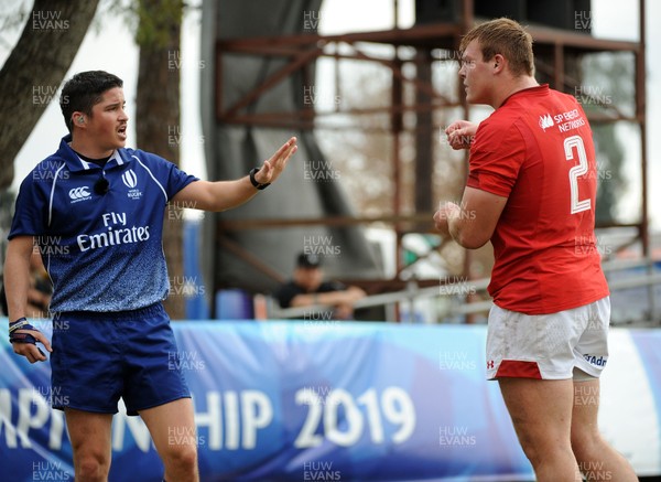 120619 - Wales U20 v Fiji U20 - World Rugby Under 20 Championship -  Referee Pali Deluca of Argentina asks Wales captain Dewi Lake to step away as he makes a decision