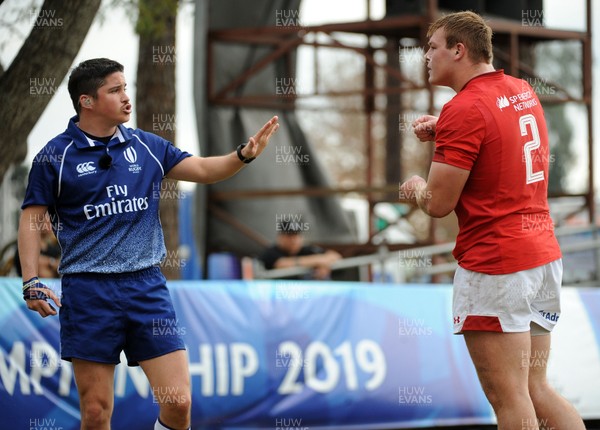 120619 - Wales U20 v Fiji U20 - World Rugby Under 20 Championship -  Referee Pali Deluca of Argentina asks Wales captain Dewi Lake to step away as he makes a decision