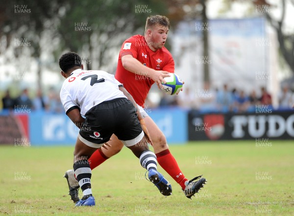 120619 - Wales U20 v Fiji U20 - World Rugby Under 20 Championship -  Tom Devine of Wales takes on Fiji hooker Lino Mairara