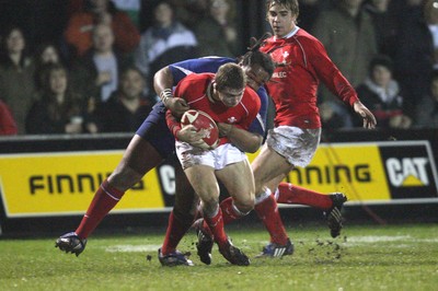14.03.08 ..  Wales U20 v France U20, U20 Six Nations, Newport -  Wales' Leigh Halfpenny is takled by France's Mathieu Basteraud  