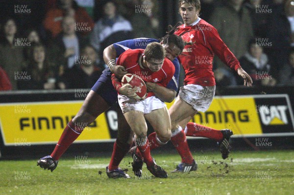 14.03.08 ..  Wales U20 v France U20, U20 Six Nations, Newport -  Wales' Leigh Halfpenny is takled by France's Mathieu Basteraud  