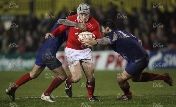 14.03.08 ..  Wales U20 v France U20, U20 Six Nations, Newport -  Wales' Jonathan Davies takes on France's Mathieu Belie and Raphael Lakafia 