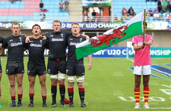 070618 -  Wales U20 v Japan U20, World Rugby U20 Championship, Pool A - Left to right, Ioan Nicholas of Wales, Dewi Cross of Wales, Jack Pope of Wales and Tommy Reffell of Wales during the anthems ahead of the match against Japan