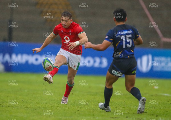 290623 - Wales v Japan - World Rugby U20 Championship - Dan Edwards of Wales kicks the ball behind Kosho Muto of Japan