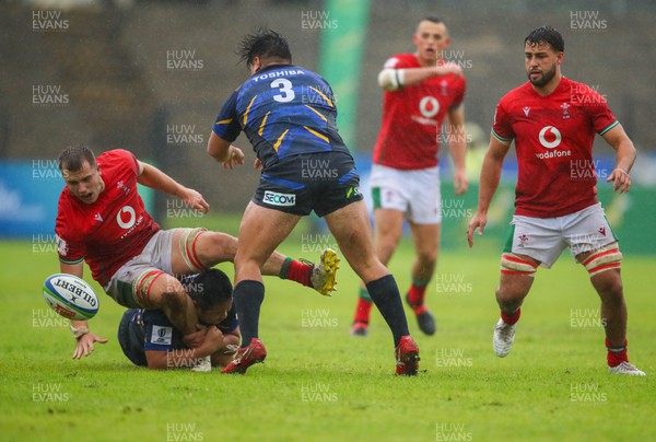 290623 - Wales v Japan - World Rugby U20 Championship - Morgan Morse of Wales is tackled by Hwang Sena of Japan