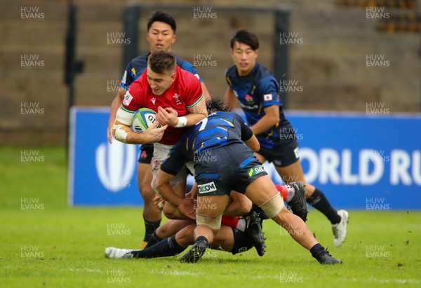290623 - Wales v Japan - World Rugby U20 Championship - Tom Florence of Wales is tackled  by Japanese players