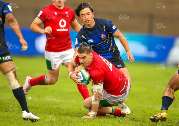 290623 - Wales v Japan - World Rugby U20 Championship - Bryn Bradley of Walesis tackled by Kanjiro Maramoto of Japan
