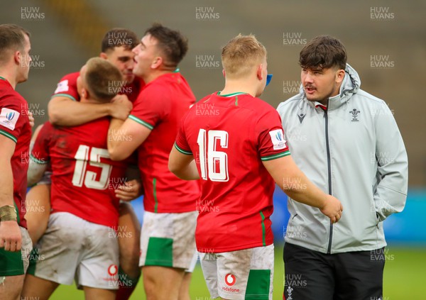 290623 - Wales v Japan - World Rugby U20 Championship - an ecstatic Welsh team, congratulate each other