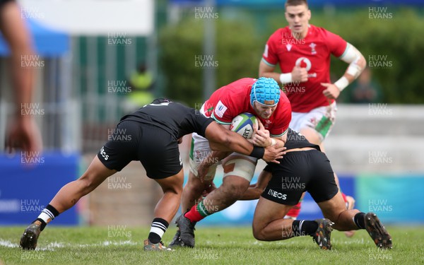240623 - Wales v New Zealand - World Rugby U20 Championship - Liam Edwards of Wales is tackled by Aki Tuivailala of New Zealand and New Zealand captain Noah Hotham