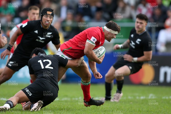 240623 - Wales v New Zealand - World Rugby U20 Championship - Ajay Faleafaga of New Zealand tackles Lewis Lloyd of Wales