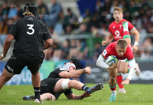 240623 - Wales v New Zealand - World Rugby U20 Championship - Cameron Winnett of Wales is tripped by Tahlor Cahill of New Zealand (L)