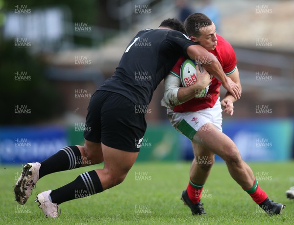 240623 - Wales v New Zealand - World Rugby U20 Championship - Ben Ake of New Zealand tackles Louie Hennessey of Wales