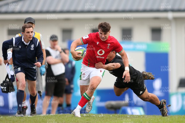 240623 - Wales v New Zealand - World Rugby U20 Championship - Llien Morgan of Wales attempts to slip New Zealand captain Noah Hotham tackle 