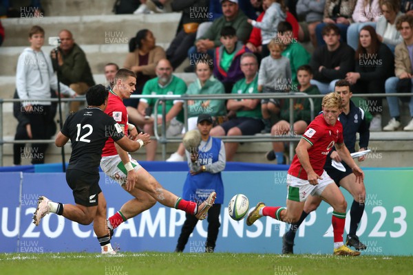 240623 - Wales v New Zealand - World Rugby U20 Championship - Bryn Bradley of Wales grubber kicks the ball ahead