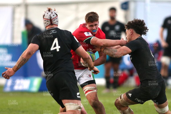 240623 - Wales v New Zealand - World Rugby U20 Championship - Evan Hill of Wales attempts to hand off Che Clark of New Zealand