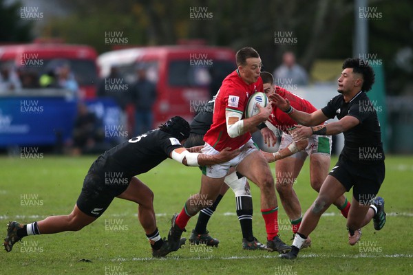 240623 - Wales v New Zealand - World Rugby U20 Championship - Louie Hennessey of Wales attempts to get past Aki Tuivailala of New Zealand and Codemeru Vai of New Zealand attempted tackle 