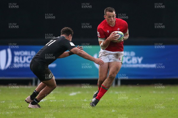 240623 - Wales v New Zealand - World Rugby U20 Championship - Louie Hennessey of Wales attempts to get past Macca Springer of New Zealand