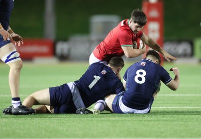 020224 - Wales v Scotland, U20 6 Nations 2024 - Harry Thomas of Wales takes on Robbie Deans of Scotland and Tom Currie of Scotland