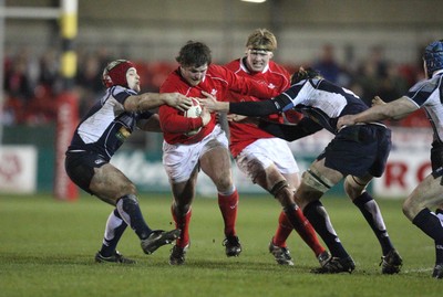 08.02.08 ... Wales U20 v Scotland U20, Newport -  Wales' Ryan Prosser is tackled by Scotlands' Lewis Calder and Josh Brown 
