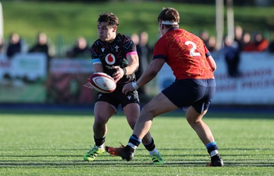 121225 - Wales U20 v Scotland U20, International Friendly - Carwyn Leggatt-Jones of Wales feeds the ball out as Joe Roberts of Scotland closes in