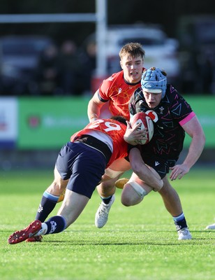 121225 - Wales U20 v Scotland U20, International Friendly - Osian Williams of Wales is tackled