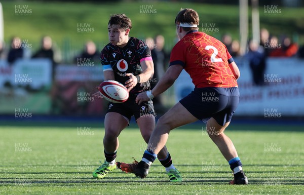 121225 - Wales U20 v Scotland U20, International Friendly - Carwyn Leggatt-Jones of Wales feeds the ball out as Joe Roberts of Scotland closes in