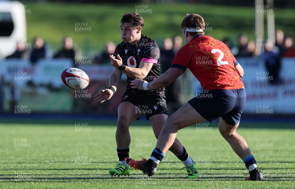 121225 - Wales U20 v Scotland U20, International Friendly - Carwyn Leggatt-Jones of Wales feeds the ball out as Joe Roberts of Scotland closes in
