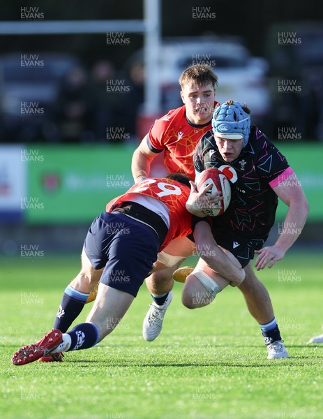 121225 - Wales U20 v Scotland U20, International Friendly - Osian Williams of Wales is tackled