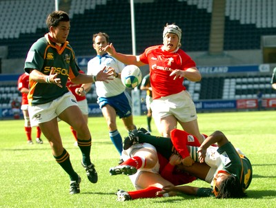 22.06.08 - Junior World Championship 2008 3rd Place Play Off - Wales v South Africa South Africa's Cecil Afrika passes to Francois Brummer as Wales' Leigh Halfpenny tackles to set up Brummer's second try 
