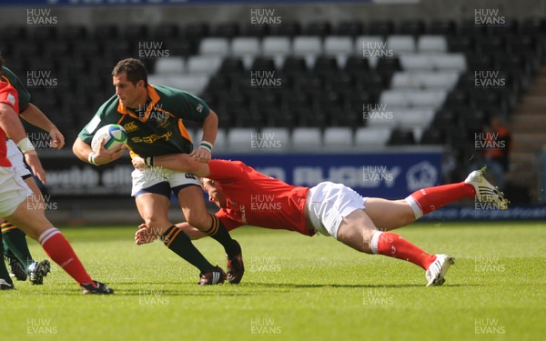 22.06.08 - Junior World Championship 2008 3rd Place Play Off - Wales v South Africa South Africa's Francois Brummer is tackled by Wales' Rhys Williams 