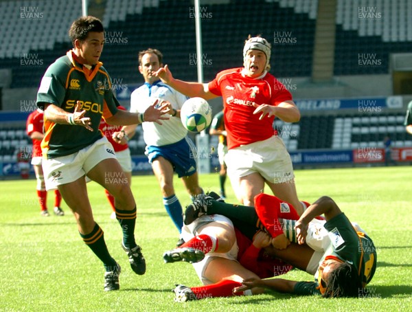 22.06.08 - Junior World Championship 2008 3rd Place Play Off - Wales v South Africa South Africa's Cecil Afrika passes to Francois Brummer as Wales' Leigh Halfpenny tackles to set up Brummer's second try 