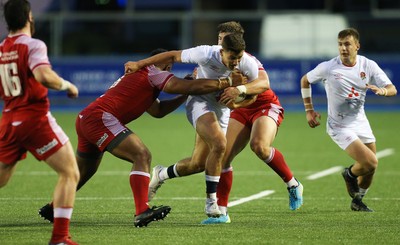 070721 - Wales U20 v England U20, 2021 Six Nations U20 Championship - Orlando Bailey of England takes on Carwyn Tuipulotu of Wales and Joe Hawkins of Wales